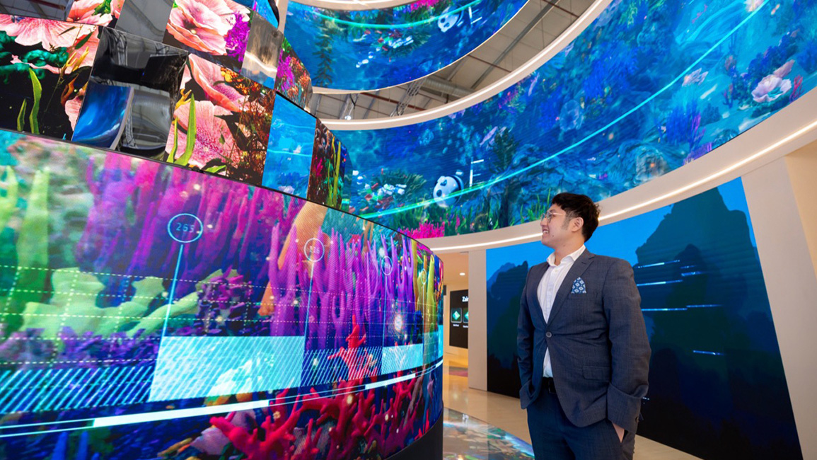 An attendee admires a 360-degree digital screen installation at LEAP, the world’s most attended technology event.